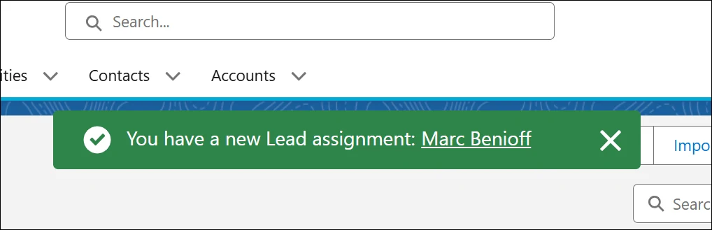 Green Salesforce toast announcing a new lead assignment, with a linked lead name and close button.