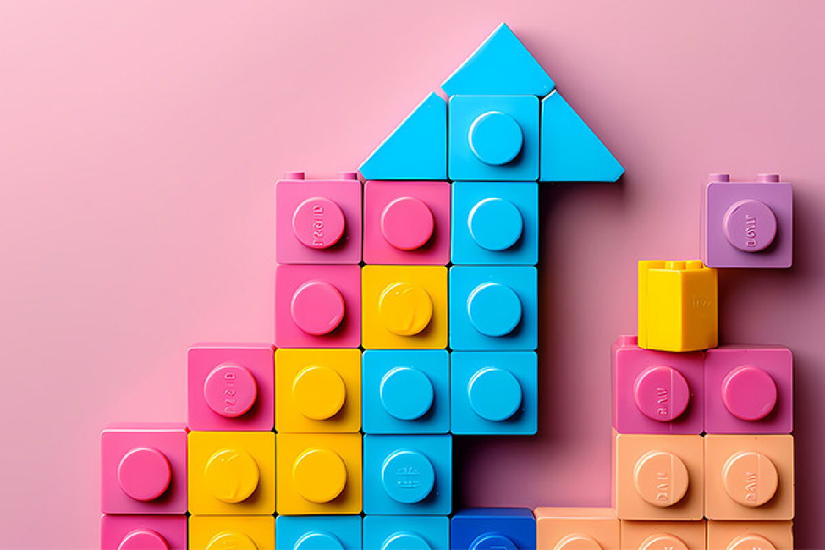 Lego blocks building upward, symbolizing the alignment and efficiency of RevOps by breaking down silos across revenue teams.