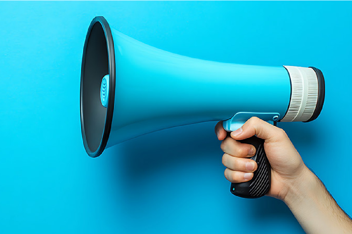 Hand holding a megaphone, symbolizing targeted communication for account-based marketing.
