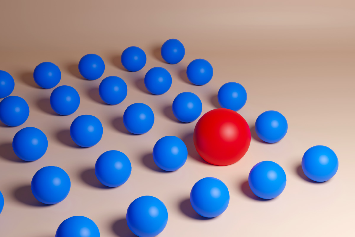 Single red marble standing out among blue marbles, symbolizing the identification of high-quality leads through lead scoring.